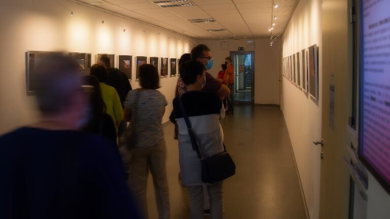 A group of people in a hallway Description automatically generated