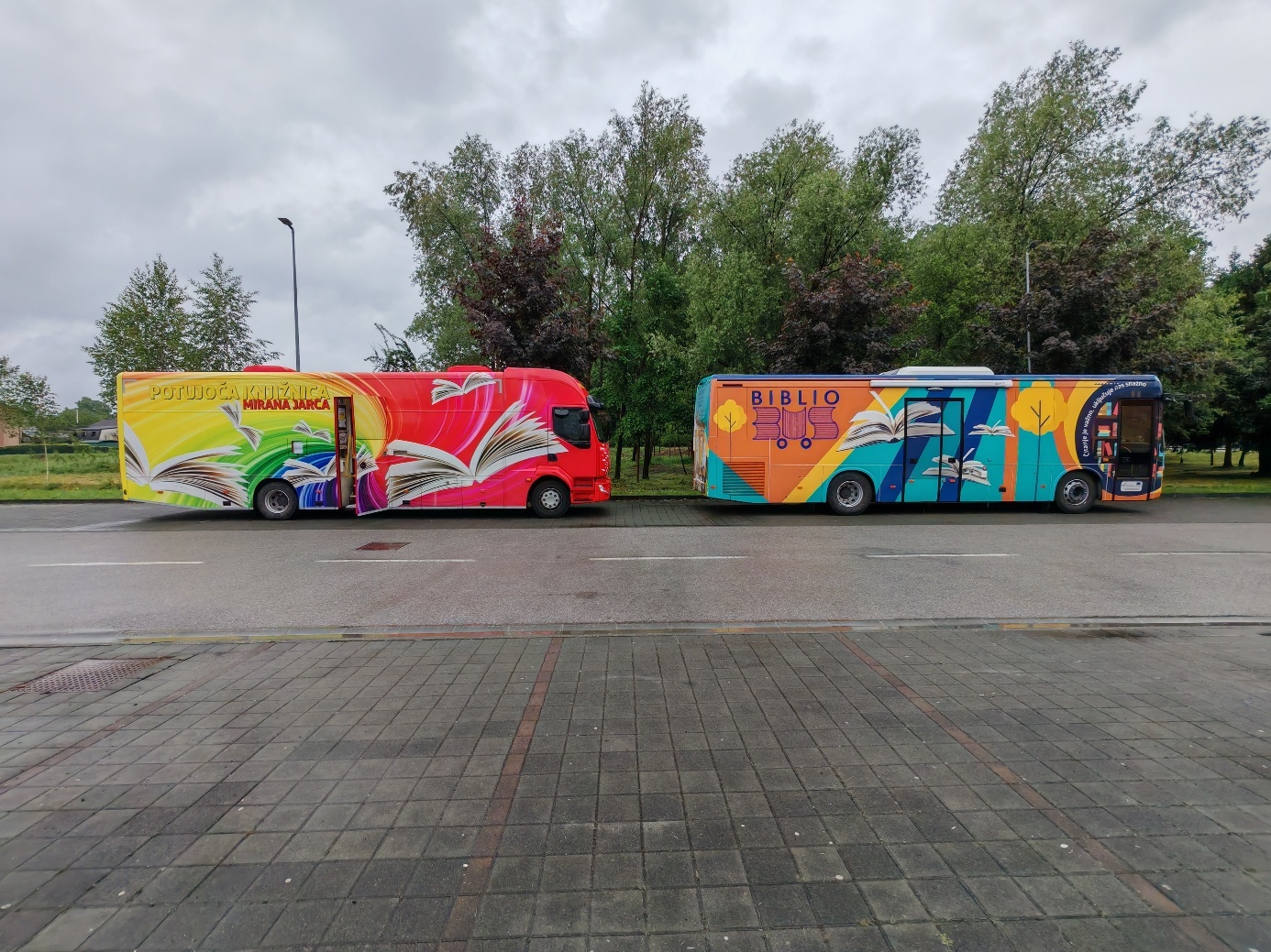 A group of buses parked on a street AI-generated content may be incorrect.