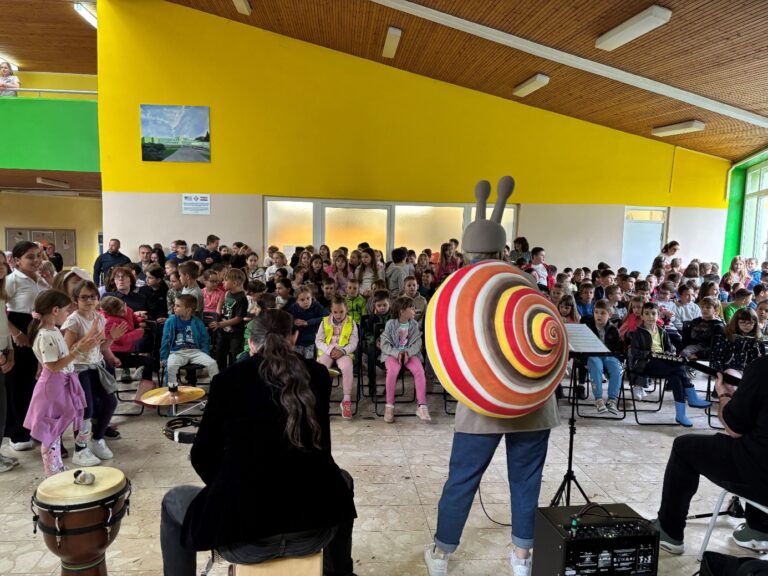 A group of people in a room with a large group of people AI-generated content may be incorrect.